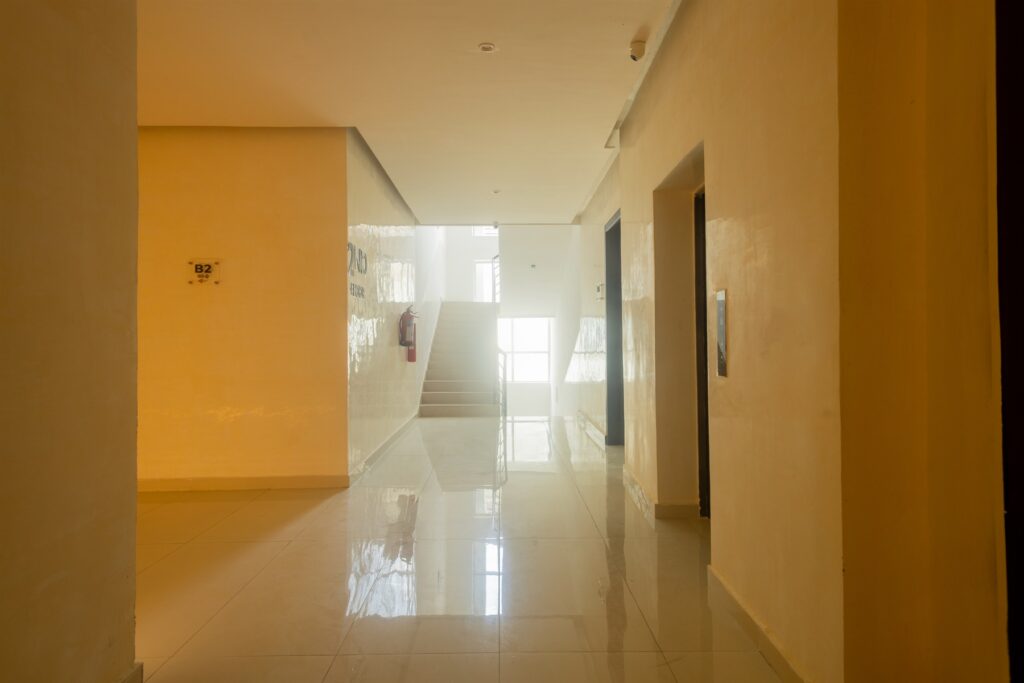 Brum Height 6: Apartment hallway opening onto a bright living area